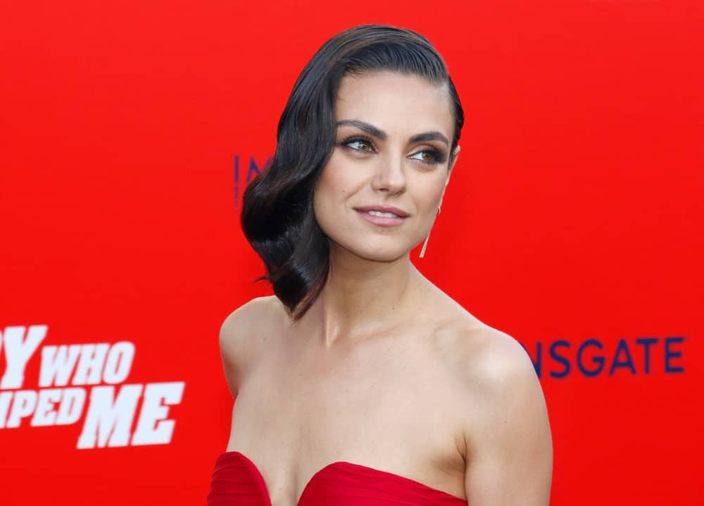 Mila Kunis was stunning and elegant in her sexy red dress complemented by a vintage look to her slick side-swept wavy hairstyle at the Los Angeles premiere of 'The Spy Who Dumped Me' held at the Regency Village Theater in Westwood last July 25, 2018.