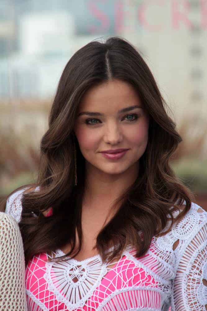 Miranda Kerr looking as youthful as ever with in this wavy, center-parted hairstyle she sported on the Victoria's Secret 2012 SWIM Collection.