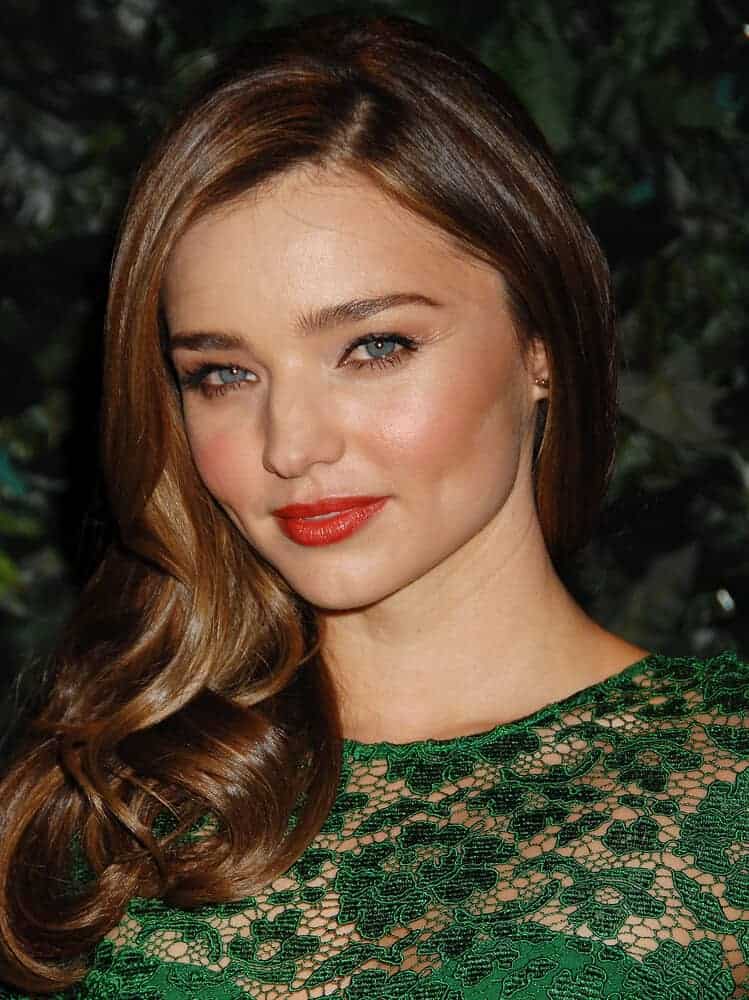 On February 22, 2013, Miranda Kerr arrives at the 4th QVC Red Carpet Style in a sophisticated green night gown and side-swept curls.