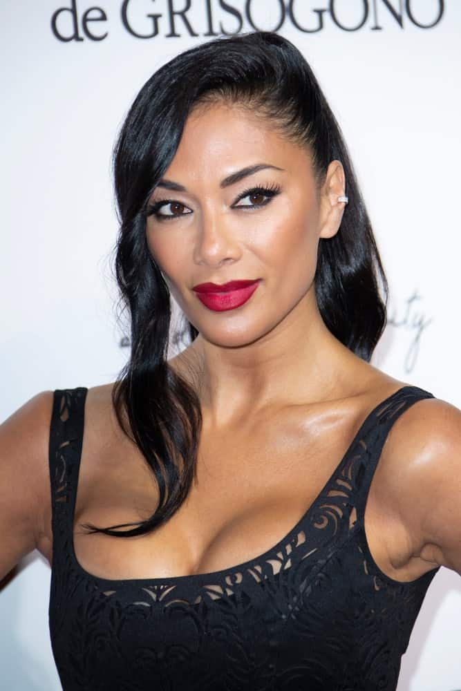 Nicole Scherzinger rocks a high ponytail hairstyle incorporated with wavy side-parted hair that's gathered on the left side. She paired it with a chic black dress that she wore during the 71st annual Cannes Film Festival in Antibes last May 15, 2018.