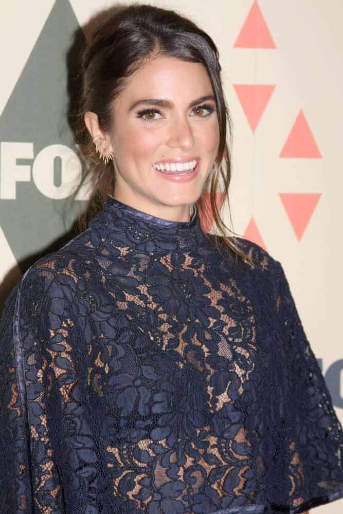 Nikki Reed in a messy bun with tendrils portrayed the clash of elegance and edginess. This hairstyle is worn at the FOX Summer TCA All-Star Party 2015 at the Soho House last August 6, 2015.