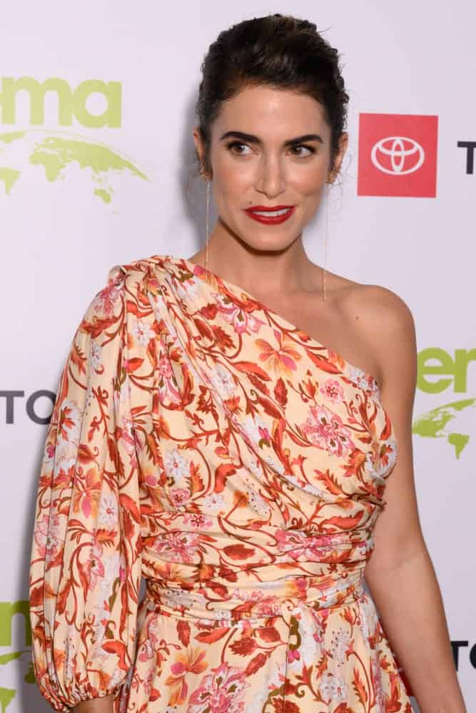 During the 2nd annual Environmental Media Association (EMA) honors benefit gala on September 28, 2019, the actress flaunted a semi-tousled updo hairstyle accentuating her dangling earrings. The look was completed with a floral, one-shoulder dress.