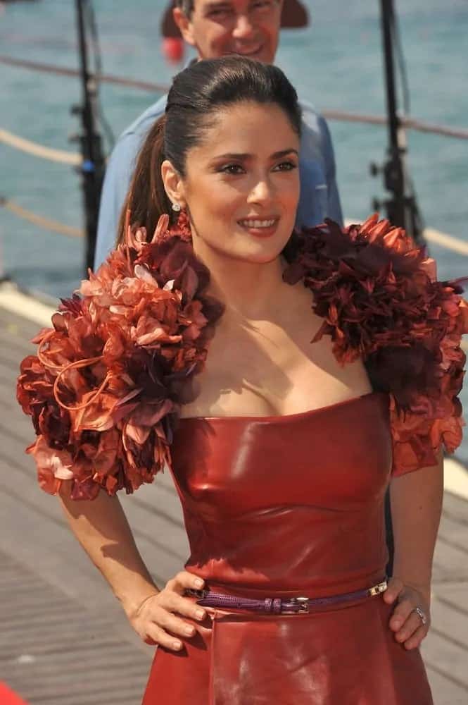 The stunning actress wore a red leather dress paired with a sleek ponytail at the photocall for her new animated movie "Puss in Boots" last May 11, 2011.