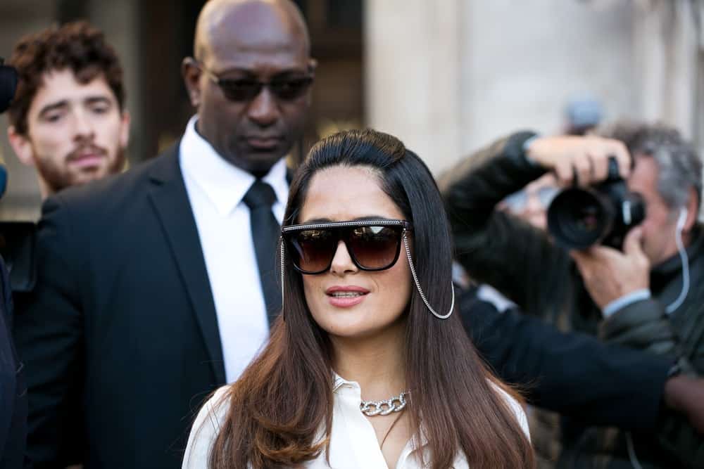 Salma Hakek was spotted last October 3, 2016 going to the Stella McCartney fashion show with her husband Francois-Henri Pinault. She was wearing a pair of fashion-forward sunglasses to complement her loose and highlighted long hair.