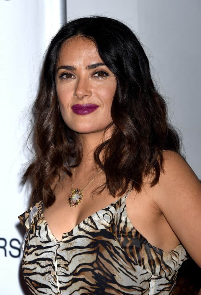 Salma Hayek wore an animal print dress and sexy tousled wavy hair at the Septembers of Shiraz Premiere last June 21, 2016 in Los Angeles.