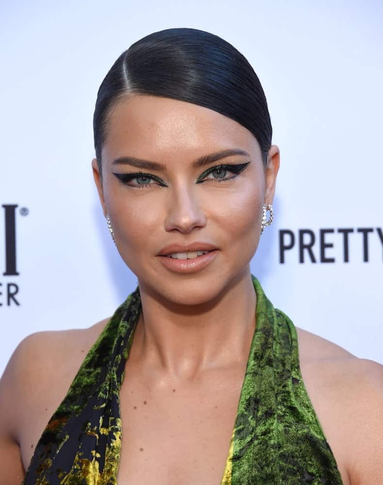 Adriana Lima arrived for the The Daily Front Row 5th Annual Fashion LA Awards on March 17, 2019 in Beverly Hills. She was a stand-out with her green confident dress and beautiful make up to complement her simple bun updo.