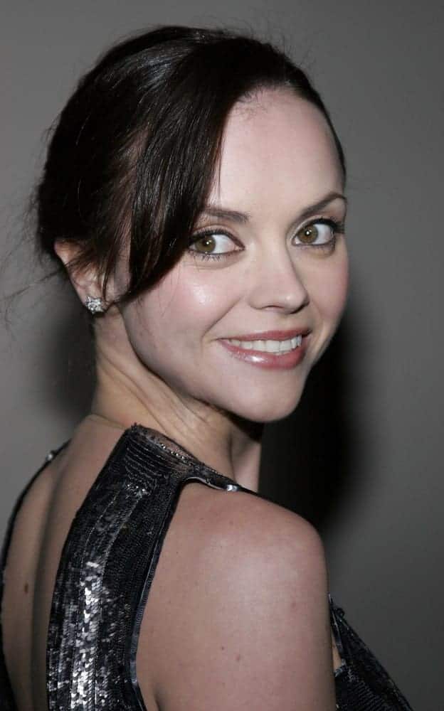 Christina Ricci was at the Rodeo Drive Walk Of Style Award honoring Gianni and Donatella Versace held at the Beverly Hills City Hall in Beverly Hills on February 8, 2007. She wore an elegant dress with her raven bun hairstyle that has long side-swept bangs.
