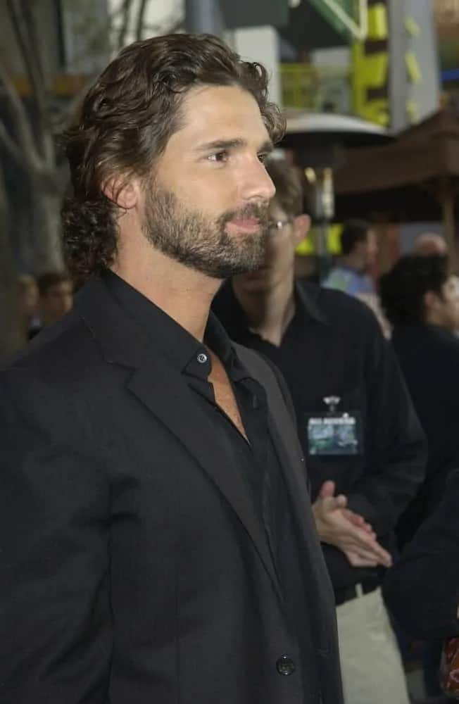 Actor Eric Bana attended the world premiere of his new movie The Hulk at Universal Studios Hollywood on June 17, 2003. He was seen wearing a dark suit with a long and curly dark hairstyle.