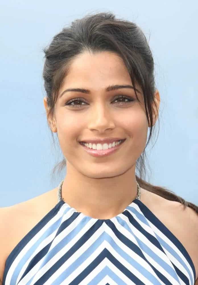 Pinto wore a simple blue-striped outfit and tousled ponytail with tendrils at the side during the 65th annual Cannes Film Festival, May 18, 2012.