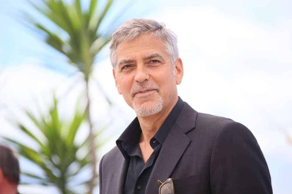 George Clooney attended the 'Money Monster' photocall during the 69th annual Cannes Film Festival at the Palais des Festivals on May 12, 2016 in Cannes, France. He paired his dark suit with a gray goatee and a gray short side-parted hairstyle.