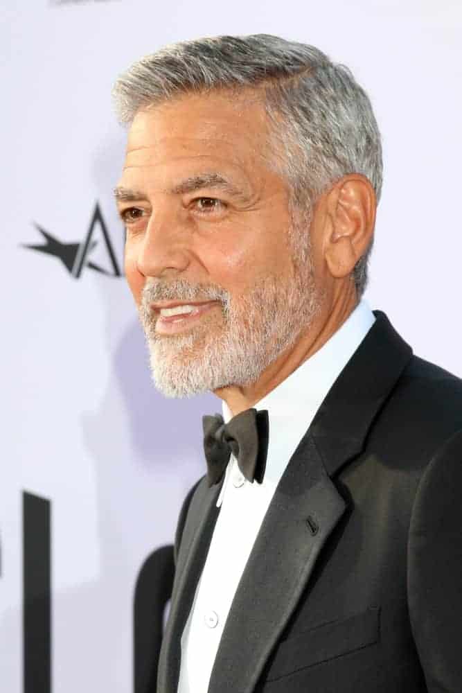 George Clooney attended the American Film Institute Lifetime Achievement Award to him at the Dolby Theater on June 7, 2018 in Los Angeles, CA. He came wearing a classic tux with his gray side-parted fade hairstyle.