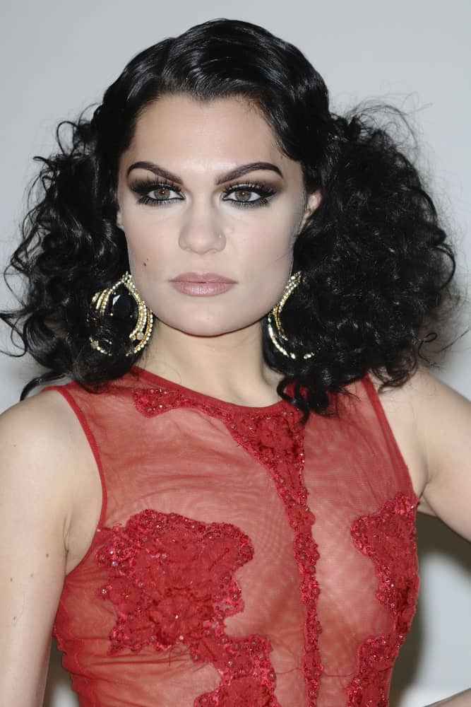 Jessie J's stunning sheer red outfit is paired with this vintage curly hairstyle that exudes sophistication last February 21, 2012 for the Brit Awards 2012 at the O2 arena in London.