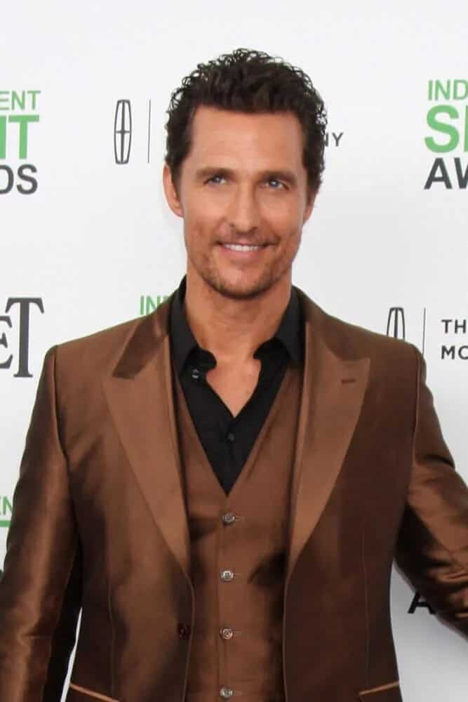 The actor gave off a confident vibe with his five o'clock shadow, shiny tan suit and fresh crew cut curly hairstyle when he attended the Film Independent Spirit Awards.