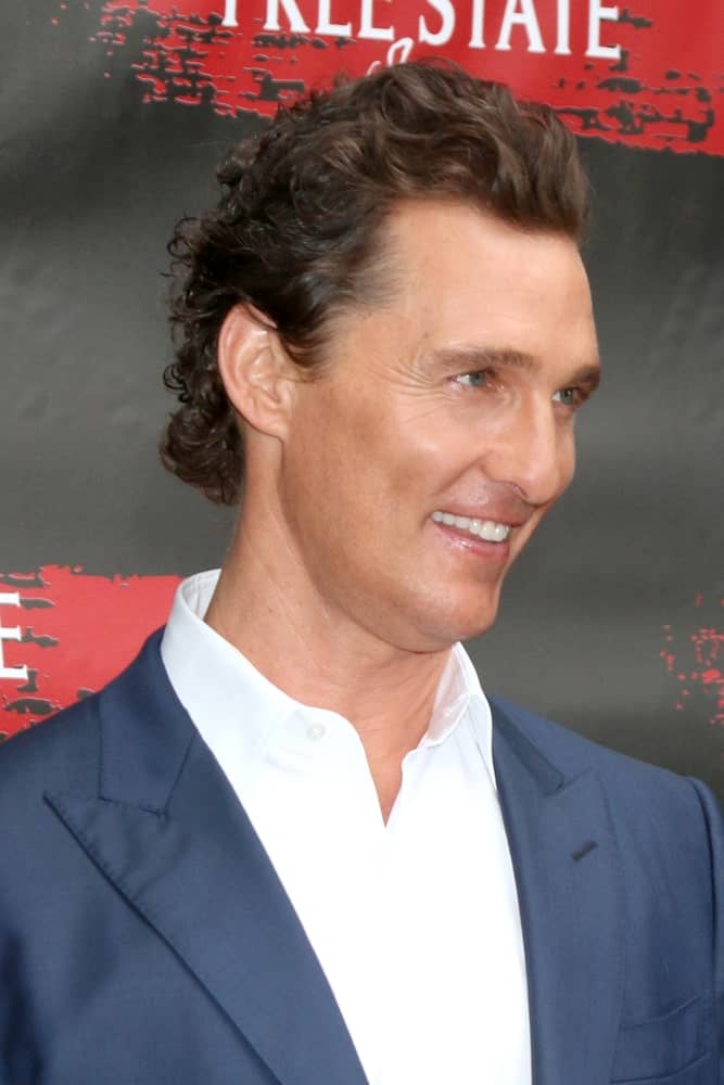 Matthew McConaughey had dark brown highlights to his brushed-back wavy curls at the Free State Of Jones Photocall at the Four Seasons Hotel Los Angeles last May 11, 2016 in Los Angeles. This is paired well with his neat clean shave and bright smile.