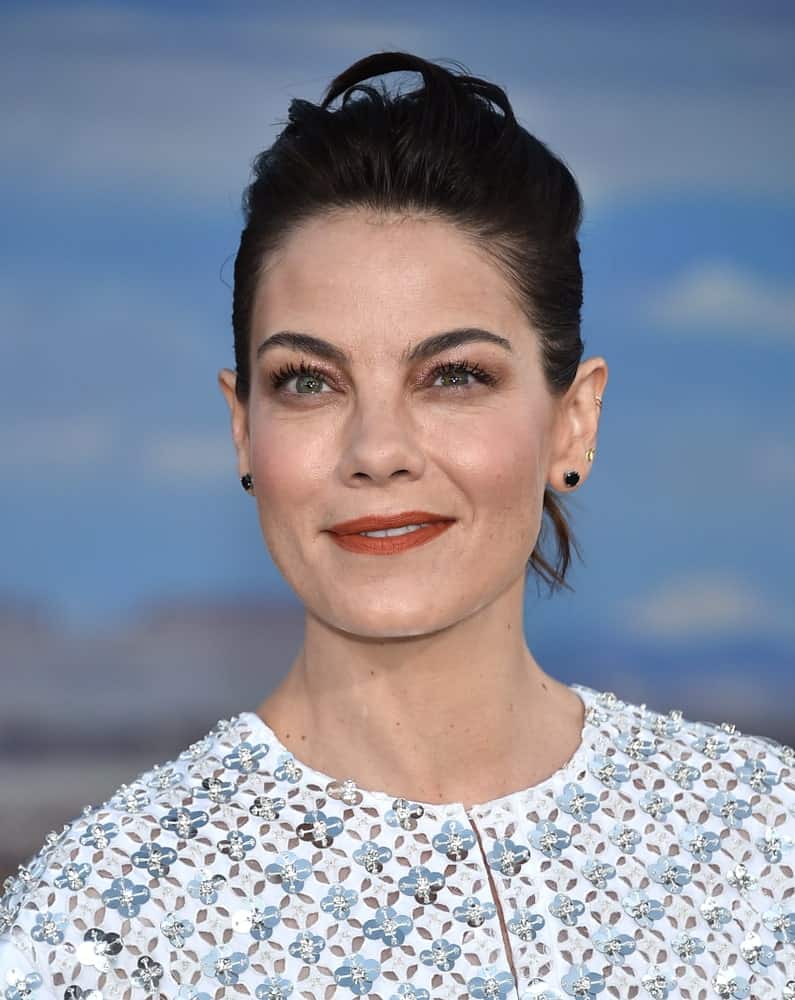 Michelle Monaghan arrives to the Netflix premiere of "El Camino: A Breaking Bad Movie" Premiere on OCT 07, 2019 in Hollywood, CA wearing a white studded sheer blouse and an updo that manages to be both messy and stylish.