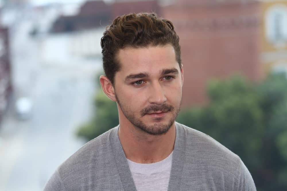 Shia LaBeouf poses for a photocall before global premiere of 'Transformers 3' movie on the roof of the Ritz hotel on June 23, 2011 in Moscow, Russia. He was wearing a simple gray sweatshirt to complement his curly fade hairstyle.