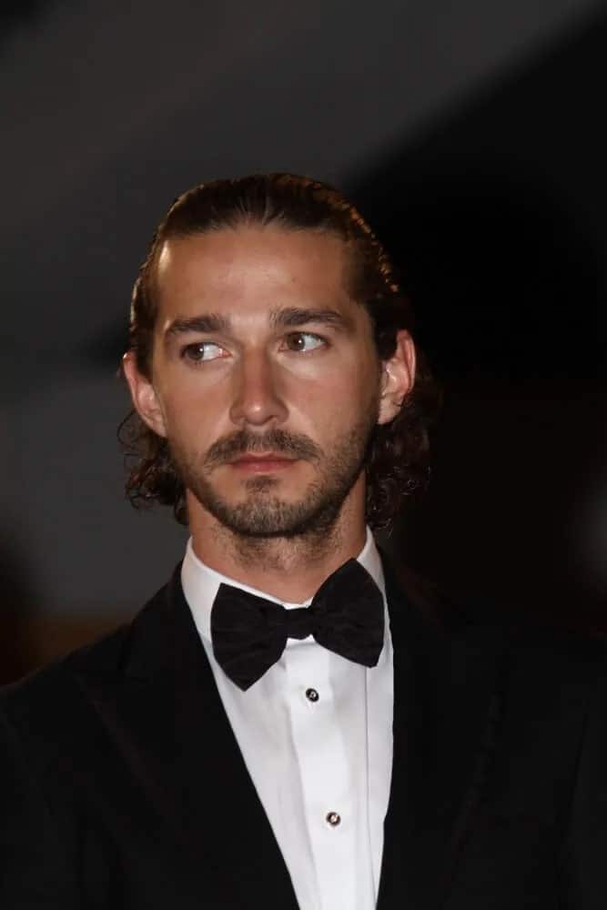 Shia LaBeouf's long curly hair was styled into this neat slicked back look matched with a well-trimmed beard last May 19, 2012 for the 65th Annual Cannes Film Festival.