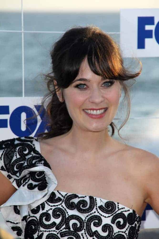 Zooey Deschanel was at the FOX All-Star Party 2011 in Gladstones, Malibu, CA on August 5, 2011. She was seen wearing a black and white dress with a messy ponytail hairstyle that has long bangs.