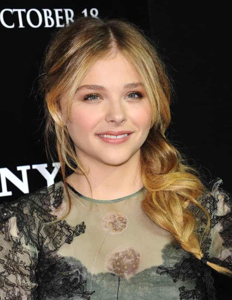 Chloe Grace Moretz attended the "Carrie" World Premiere on October 7, 2013, in Hollywood, CA. She wore a sheer green dress that went well with her side-swept wavy sandy blonde hairstyle with layers and highlights.