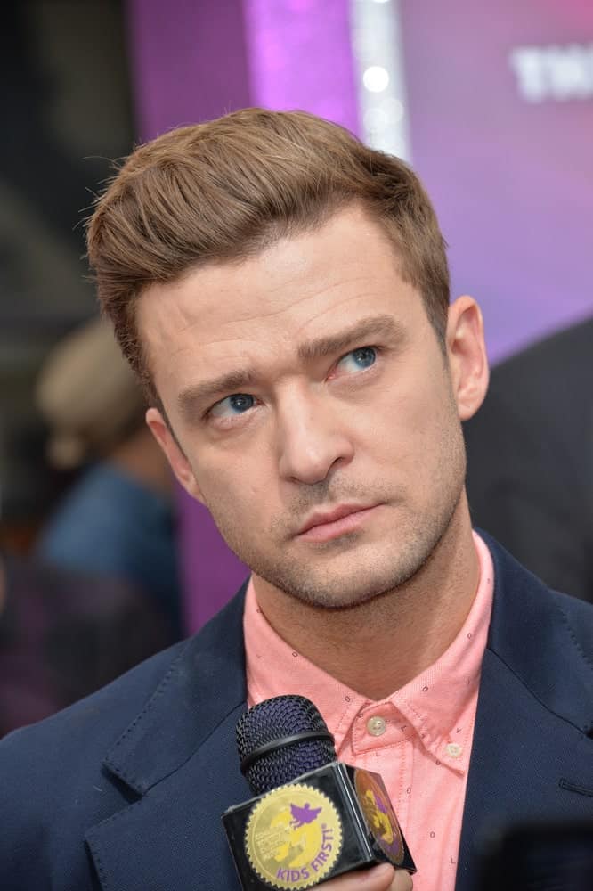 Timberlake's hair is arranged in a brushed back style during the LA premiere of "Trolls" last October 23, 2016. His hair has a slightly lighter shade to match the pink shirt and five o'clock shadow.