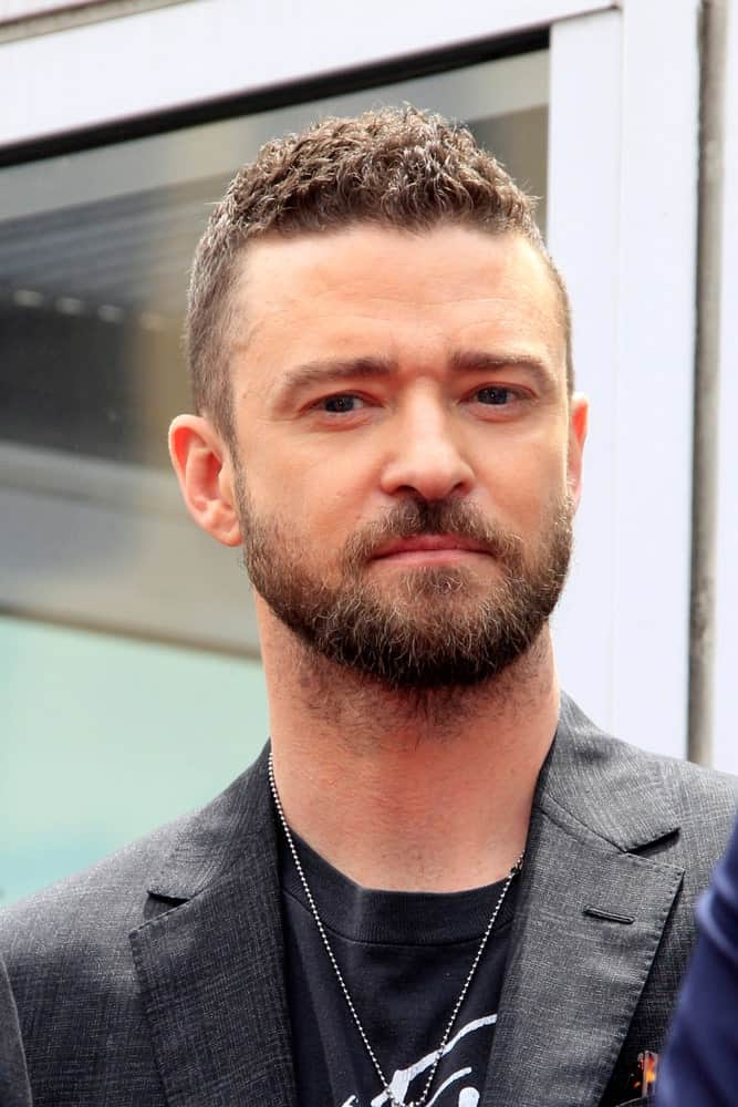 Justin Timberlake was at the *NSYNC Star Ceremony on the Hollywood Walk of Fame on April 30, 2018 in Los Angeles, CA. He went with an edgy short curl look to match his thick beard and rocker chic outfit.