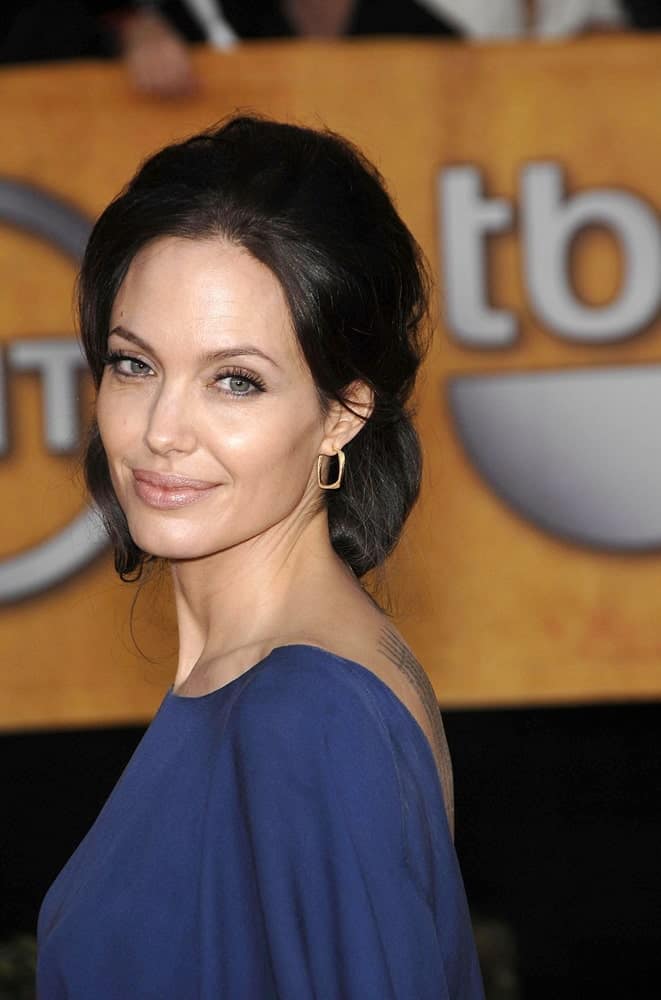 Angelina Jolie wore a simple yet elegant blue dress to match her messy and loose half-up hairstyle with a slight low bun look at the 15th Annual Screen Actors Guild SAG Awards in the Shrine Auditorium, Los Angeles, CA on January 25, 2009.