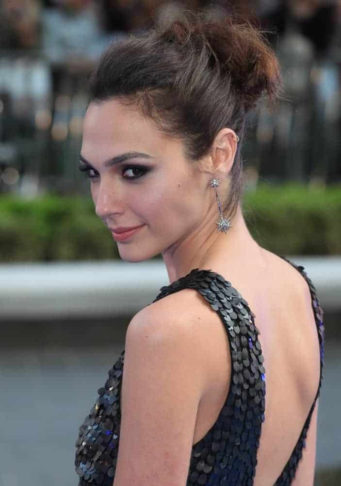 Gal Gadot attended the 'Fast And Furious 6' Premiere, in the Empire Leicester Square, London on May 7, 2013. She wore a stunning black dress that paired perfectly with her messy upstyle bun hairstyle with loose tendrils.