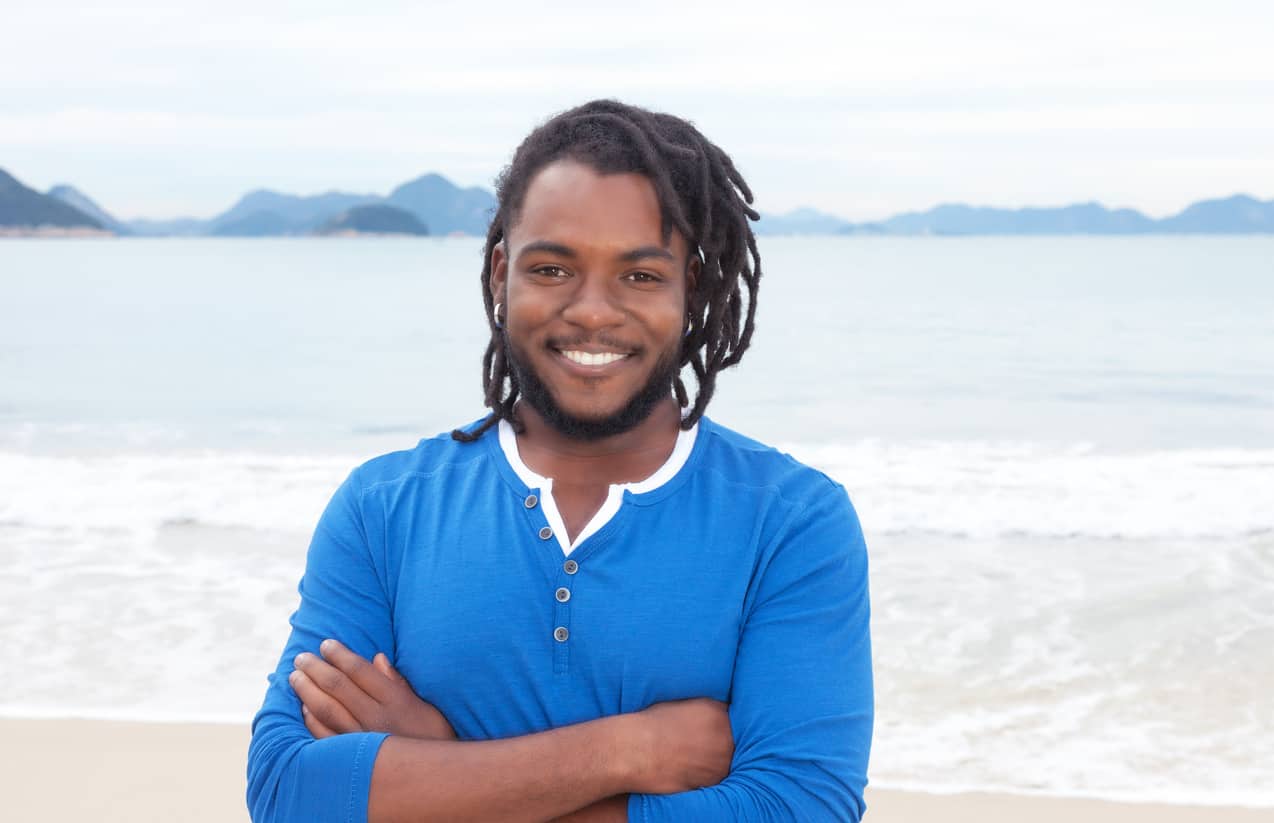 Man with dreadlocks on the beach