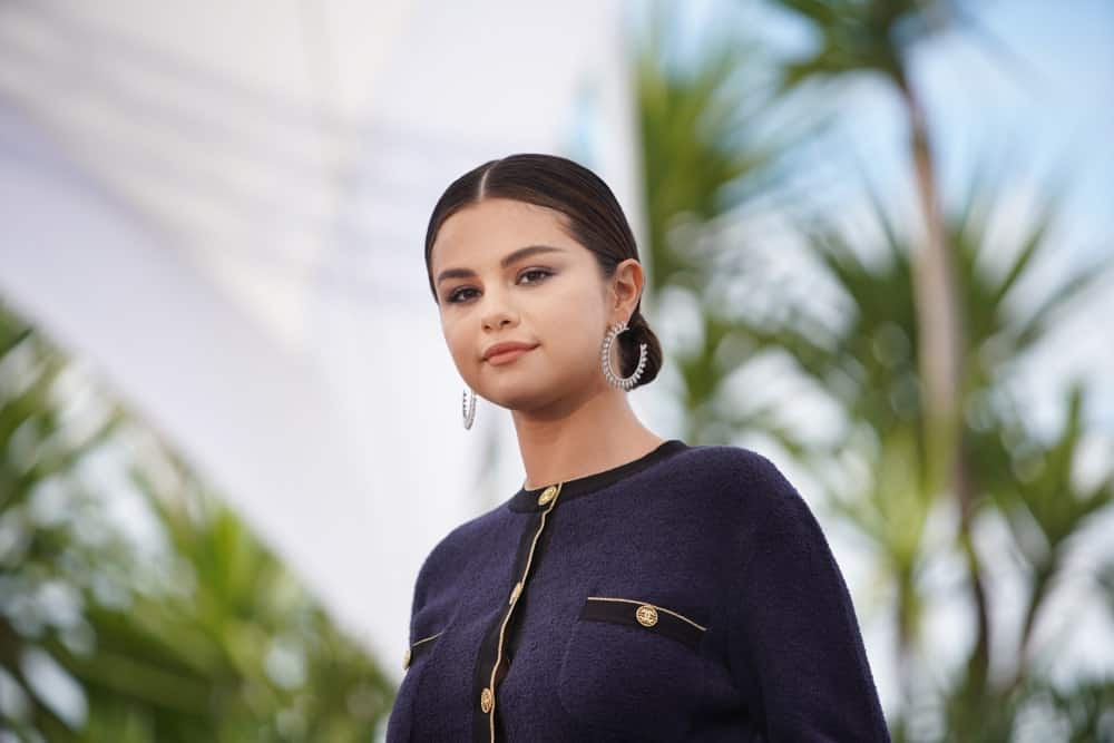 Selena Gomez attended the photocall for “The Dead Don’t Die” during the 72nd annual Cannes Film Festival on May 15, 2019, in Cannes, France. She wore a lovely navy blue outfit to match her neat and slick low bun hairstyle.