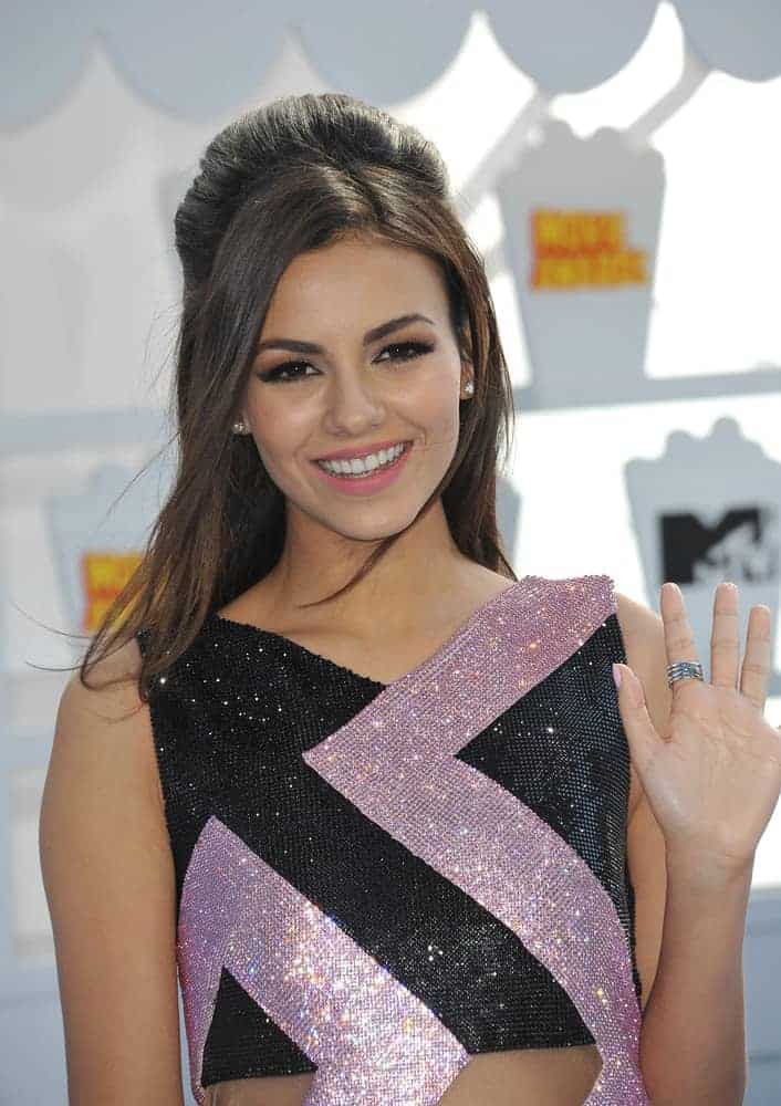 On April 12, 2015, Victoria Justice attended the 2015 MTV Movie Awards at the Nokia Theatre LA Live. She wore a bedazzled dress that went well with her long and straight half-up hairstyle that has long side bangs.