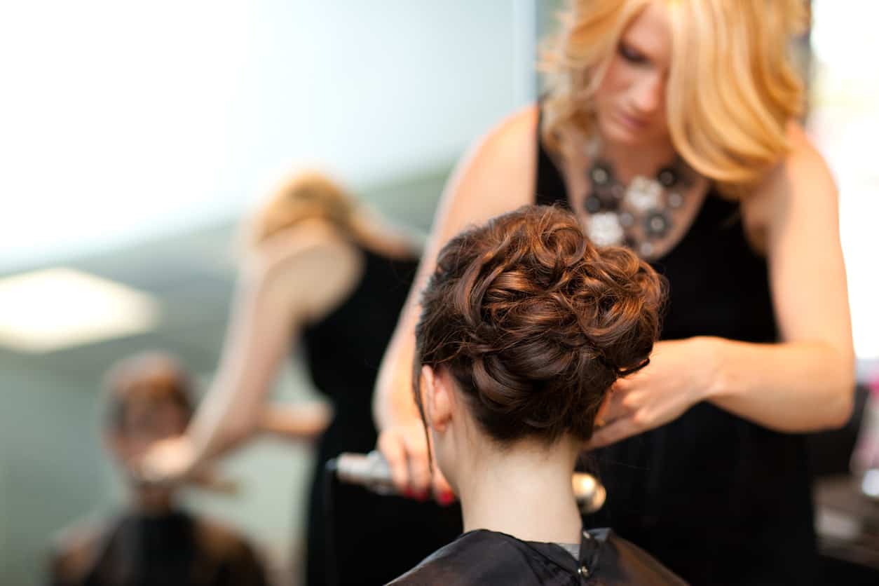 Woman with upstyle hairstyle applied in hair salon