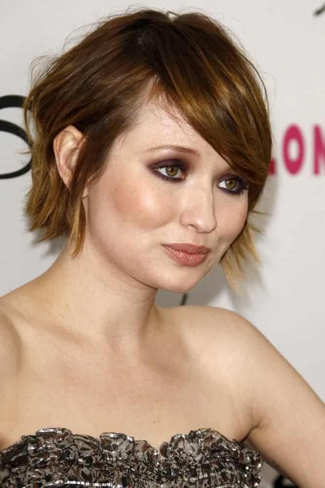 Emily Browning was at the Nylon Magazine 12th Anniversary Issue Party at Tru Hollywood on March 24, 2011, in Los Angeles, CA. She paired her black strapless dress with a pixie highlighted brunette hairstyle that has long side-swept bangs.