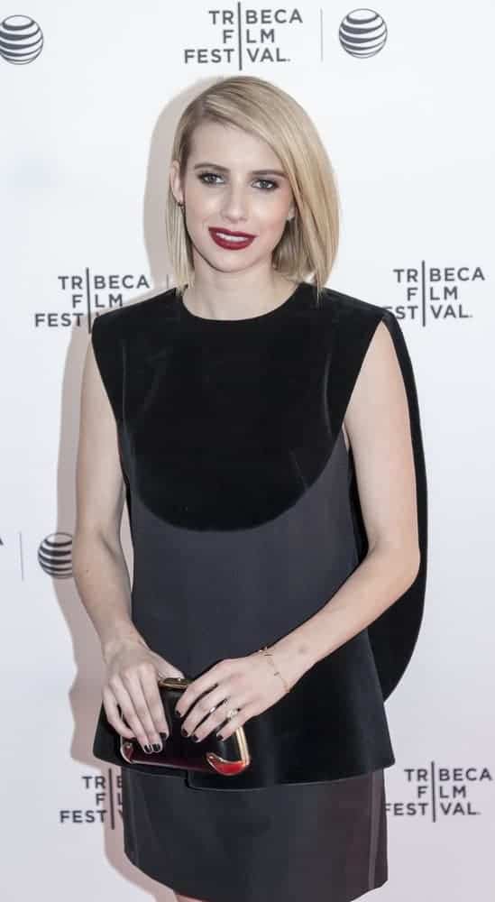 On April 24, 2014, actress Emma Roberts attended the 'Palo Alto' Premiere during the 2014 Tribeca Film Festival at the SVA Theater in New York City. She was charming in a black and gray dress that she paired with her straight chin-length bob hairstyle with side-swept bangs.