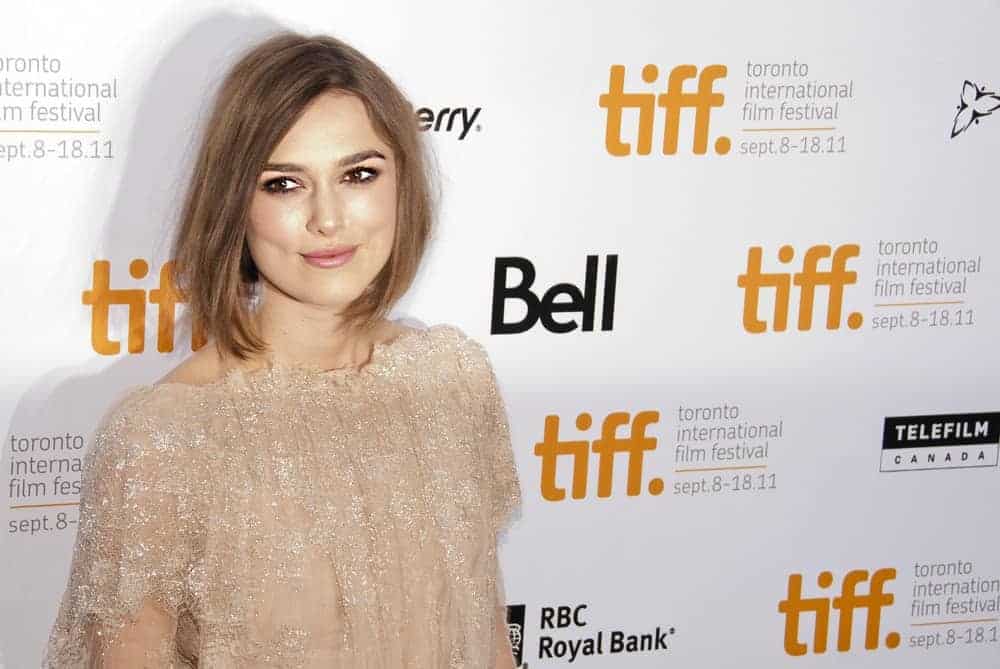 Keira Knightley graces the TIFF red carpet on September 13, 2011, at the screening of "A Dangerous Method". She wore a sparkling champagne dress with her loose and tousled brown bob hairstyle.