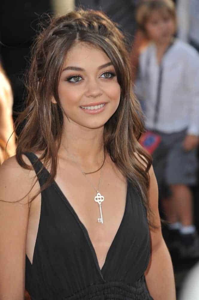 Sarah Hyland was at the premiere of "Cars 2" at the El Capitan Theatre, Hollywood on June 18, 2011. She was charming in a simple black dress and a tousled long brunette hairstyle incorporated with braids.