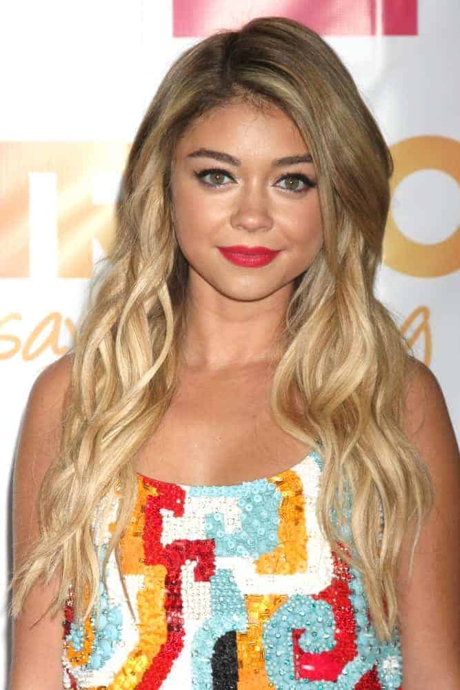 Sarah Hyland was at the "TrevorLIVE LA" at the Hollywood Palladium on December 7, 2014, in Los Angeles, CA. She wore a colorful sequined dress that she paired with her loose and tousled sandy blonde hairstyle with layers and waves.