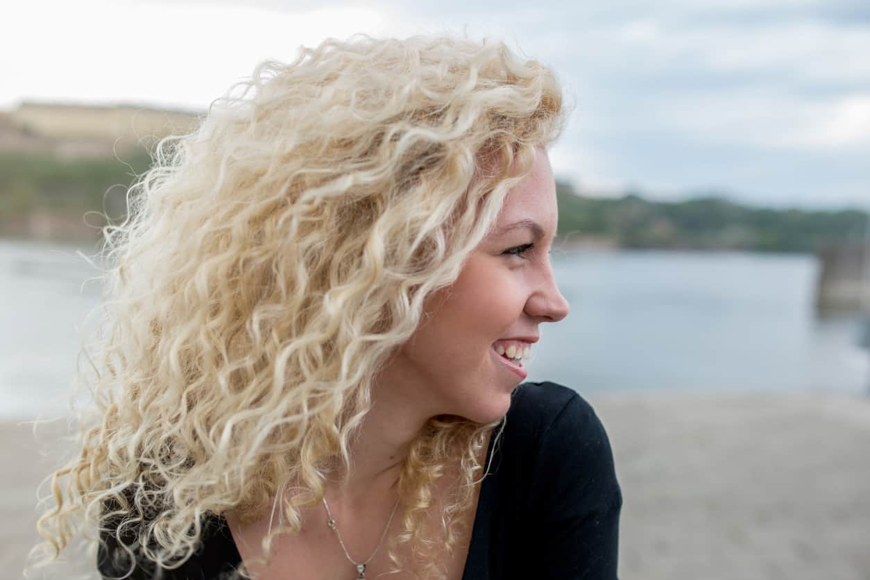 Woman with long blonde curly hair