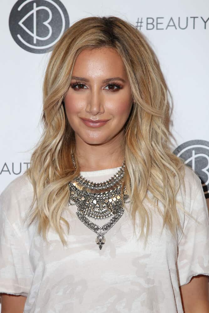 Ashley Tisdale with blonde, beach waves.