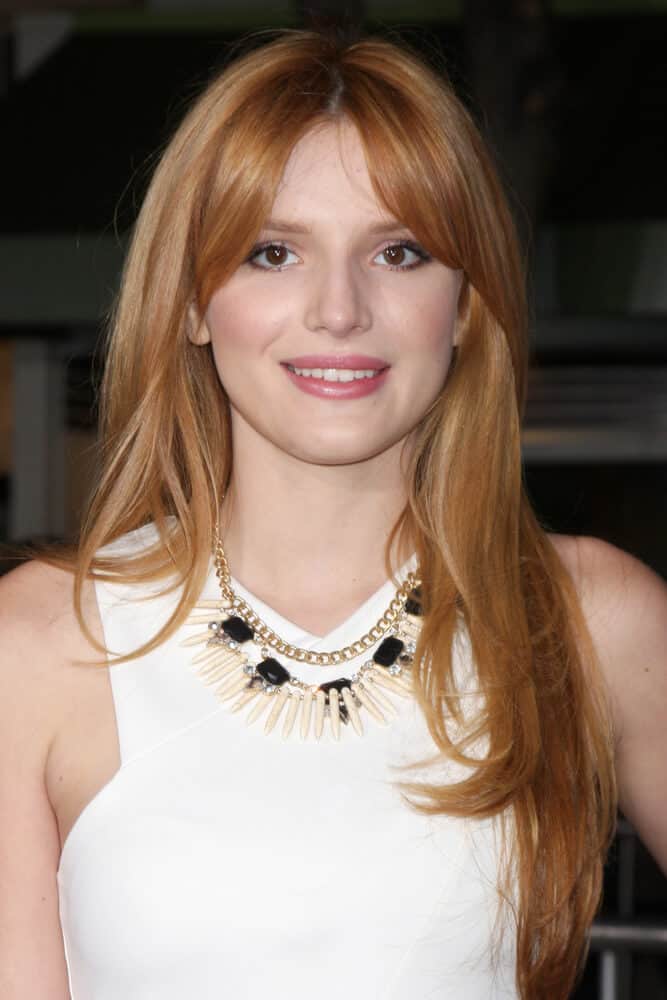 Bella Thorne with a center-parted hairstyle in Strawberry Blonde.