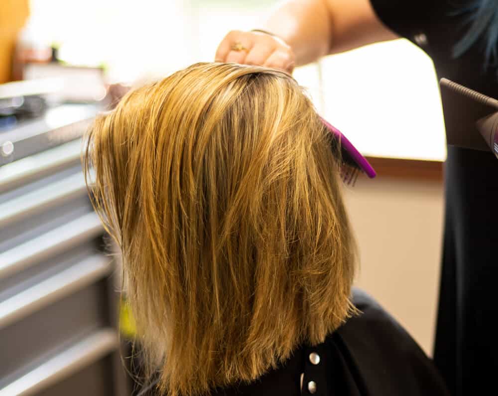 A long bob being layered for a stylish look.