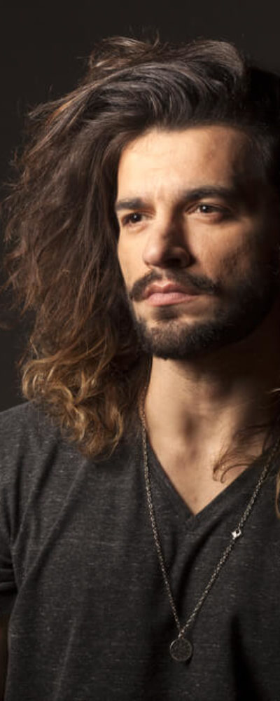 Man with long and thick, wavy hair.