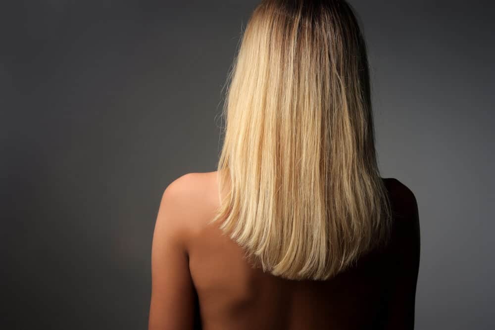 Back view of medium-length, blonde hair.