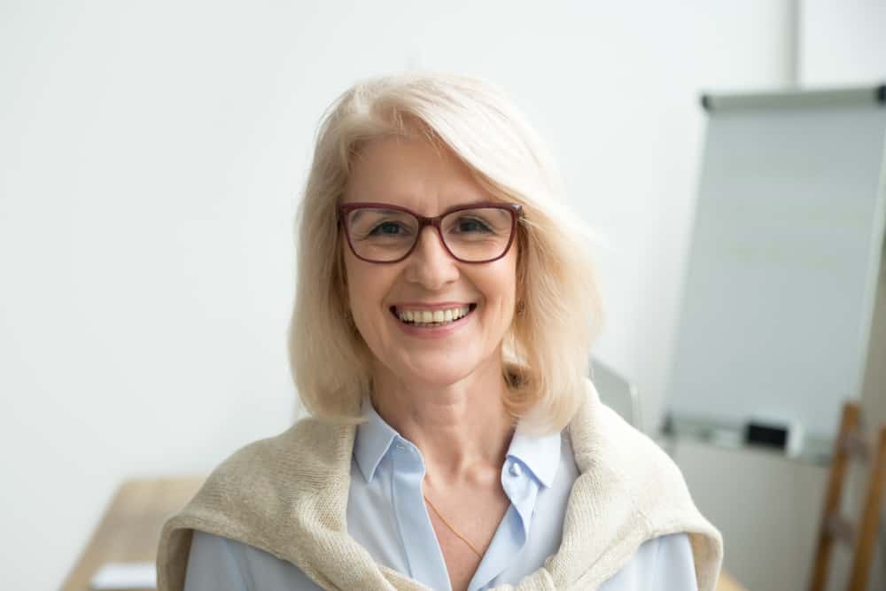 Woman over 50 with glasses.