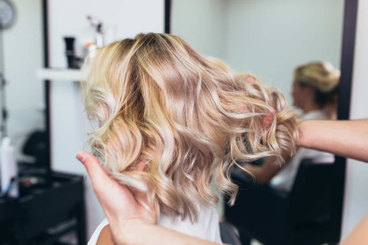 Woman with blonde fine hair at hair salon