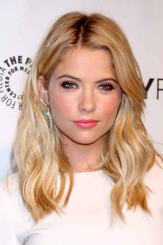 Ashley Benson attended the PaleyFEST - "Pretty Little Liars" at Dolby Theater on March 16, 2014, in Los Angeles, CA. She paired her lovely white outfit with a loose shoulder-length wavy sandy blonde hairstyle with layers and highlights.