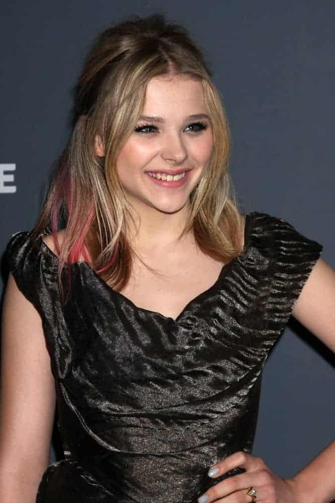 Chloe Grace Moretz was at the 14th Annual Costume Designers Guild Awards at the Beverly Hilton Hotel on February 21, 2012, in Beverly Hills, CA. She came wearing a black dress that she paired with a highlighted brunette half-up hairstyle with layers and a slight tousle.
