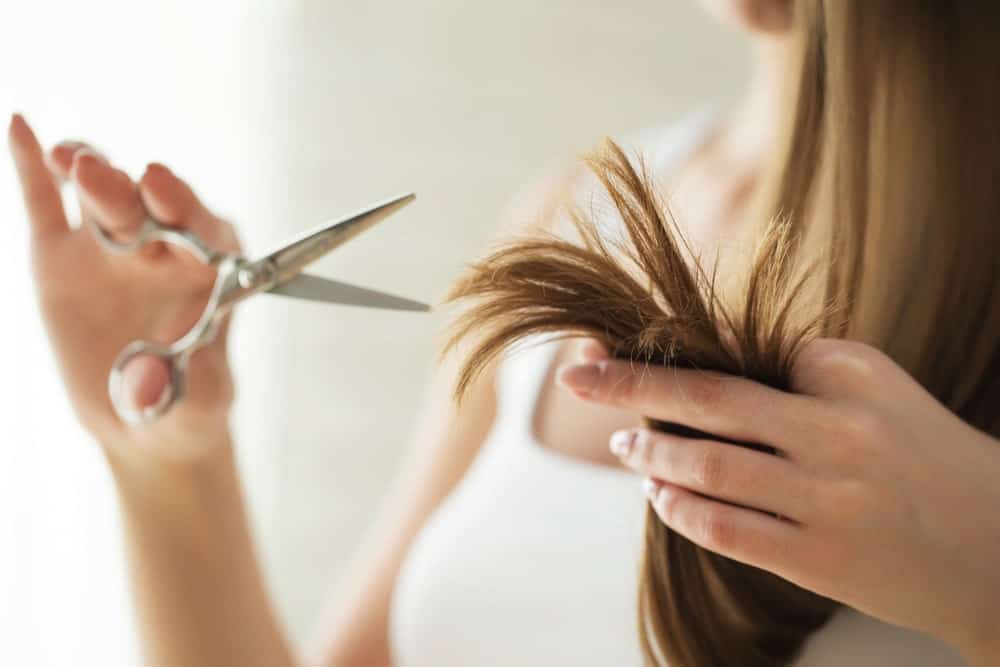 A woman who is about to cut her hair.