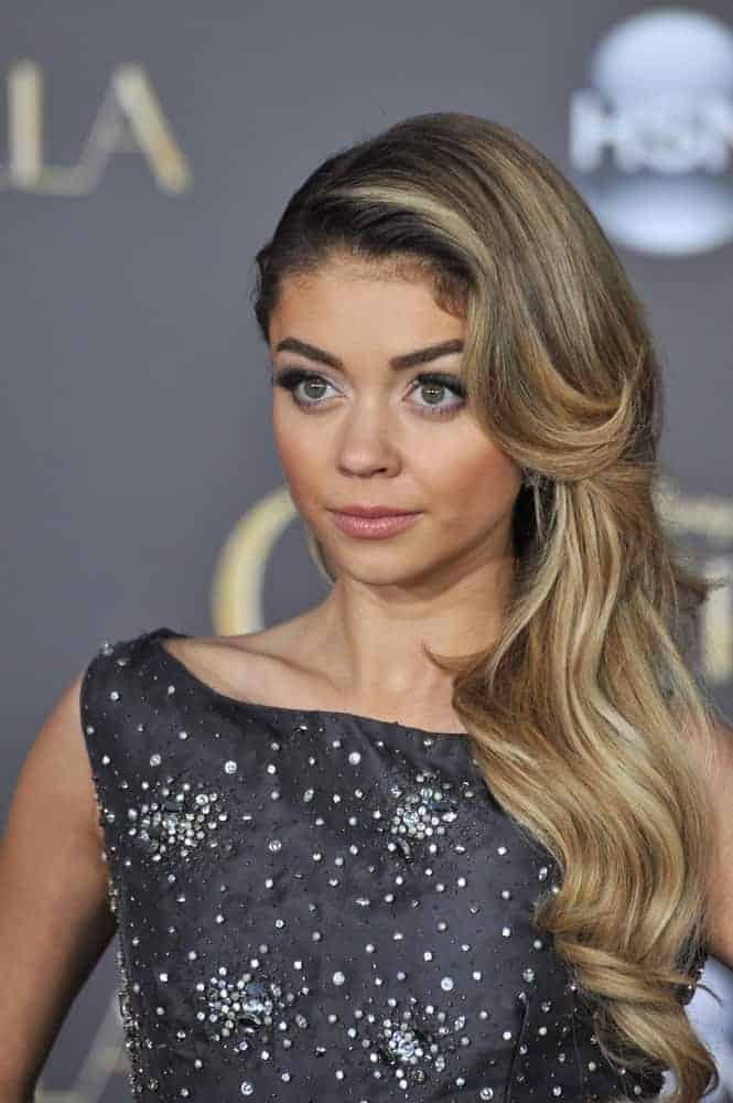 On March 1, 2015, Sarah Hyland at the world premiere of "Cinderella" at the El Capitan Theatre, Hollywood. She wore a bedazzled dress that she paired with her elegant side-swept hairstyle with layers, waves, and a sandy blonde tone.