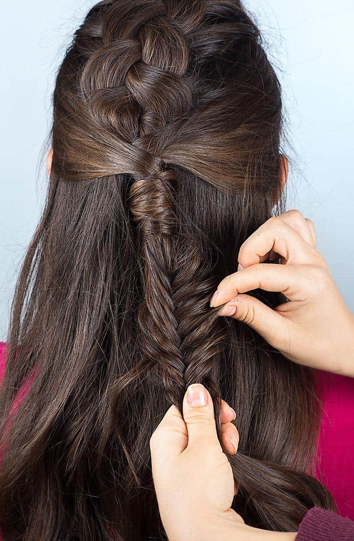 Step 9: Finish the fishtail braid and pull on each strand in order to loosen the braid and create a more relaxed look.