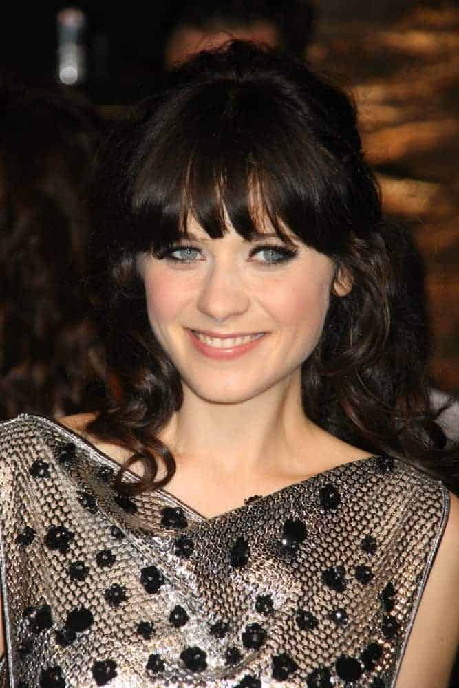 Zooey Deschanel attended the 2007 Vanity Fair Oscar Party at Morton's in West Hollywood, CA on February 25, 2007. She was seen wearing a lovely gray dress with her long and curly raven hairstyle that has bangs and a slight tousle.